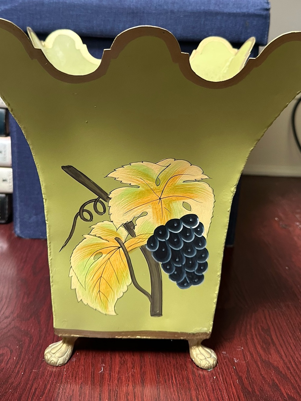 Grape motif metal planter green with gold accents.
